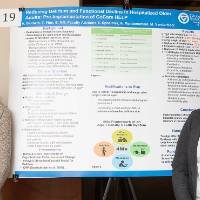 Elizabeth Hill (left) and Autumn Baldwin (right) from the Doctor of Nursing Practice program standing in front of their and Thomas Finn's poster.